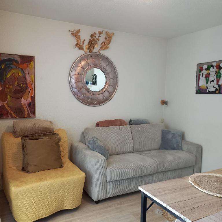 a living room with a couch and a chair at Studio SAFARI in Luchon
