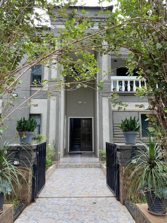 an entrance to a house with potted plants at The Stone Duplex Apartment House 1 in Lilongwe
