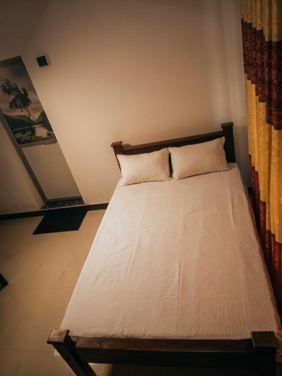 a bed with two pillows on it in a room at kuma holiday resort in Meda-Ela