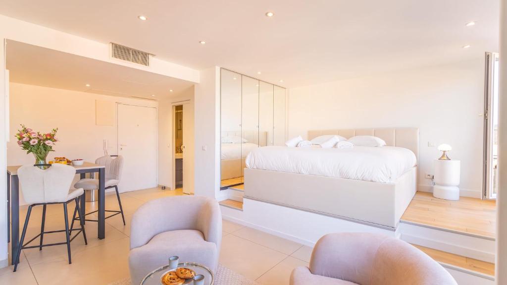 a bedroom with a bed and a table and chairs at Le Semiramis l Central & Views l Shellter Rentals in Saint-Tropez