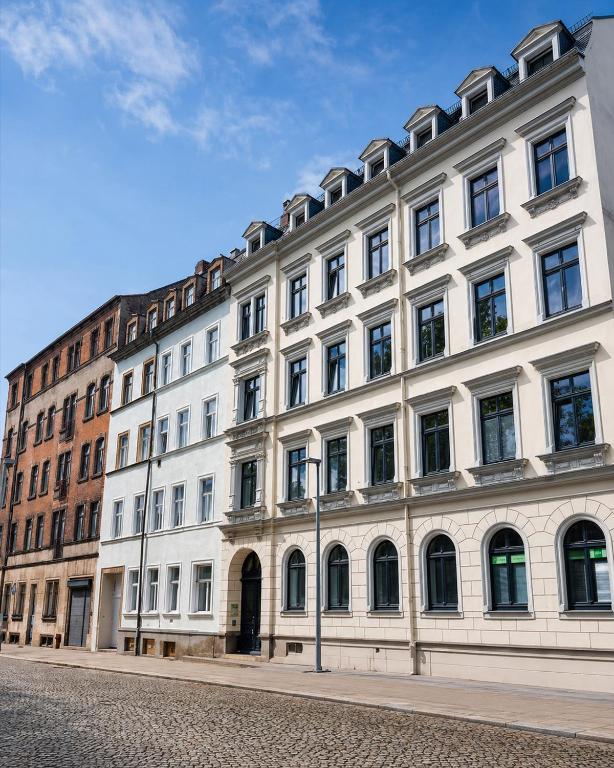 a large white building with many windows on a street at BaB Hotels and Apartments Apolo 3 in Chemnitz