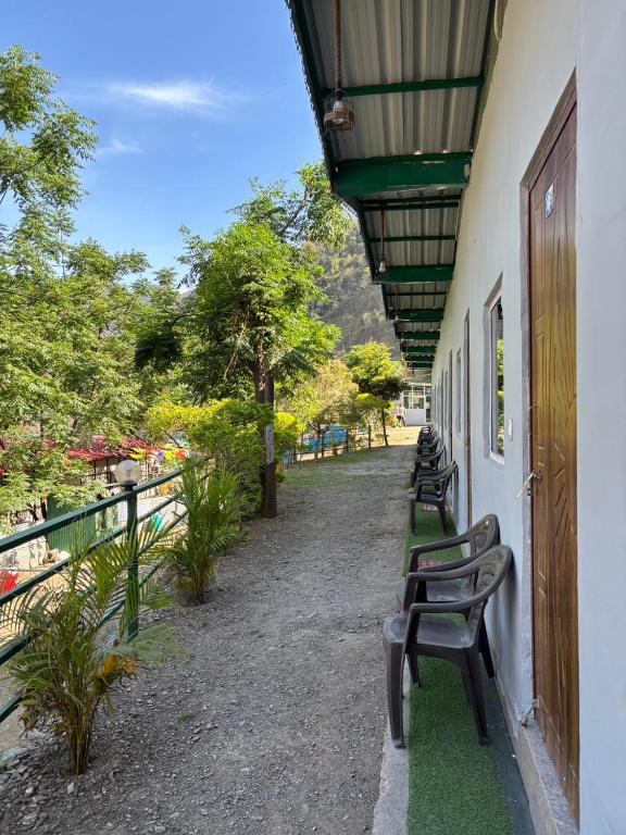 a row of benches sitting on the side of a building at Stay Maasa Resort in Shivpuri