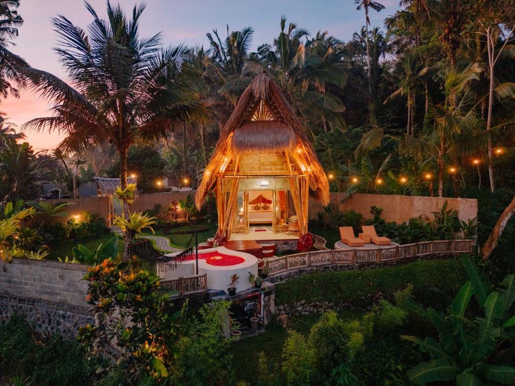 a backyard with a gazebo with a fireplace at Bambu Teras Viewpoint in Karangasem