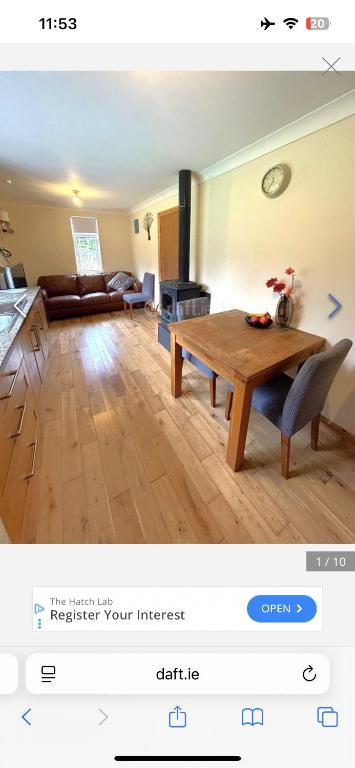 a living room with a wooden table and a couch at Stickens Apartment in Naas