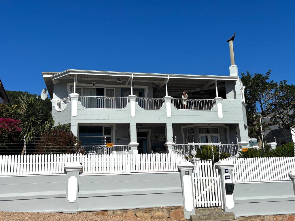 a white house with a white picket fence at Authentic Mossel Bay in Mossel Bay