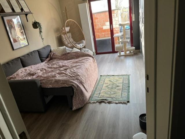 a bedroom with a bed and a rug on the floor at Room 1 km from tomorrowland in Boom