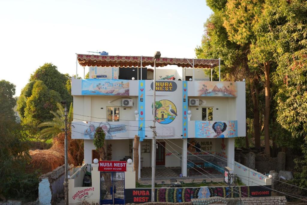 a building with paintings on the side of it at Nuba Nest in Aswan