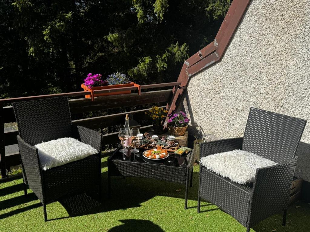 two chairs and a table with a tray of food at Wuthering Heights in Angolo Terme