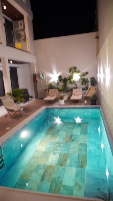 a large swimming pool in a living room at VillaRama in Saint-Louis