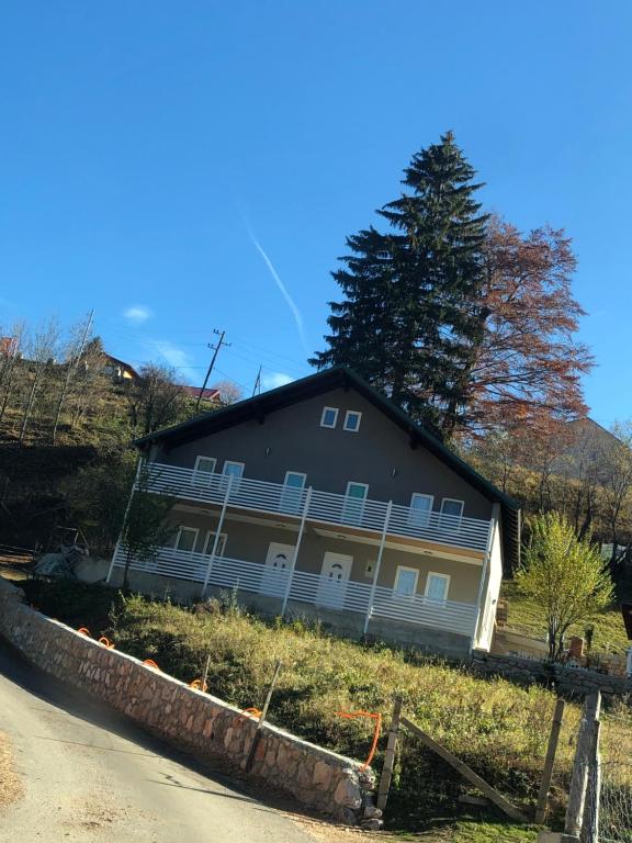 a house on a hill with a tree in the background at Rugova Vila in Peje