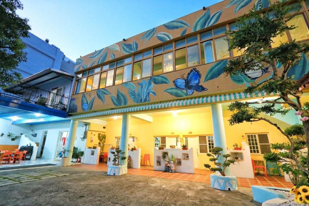 a building with butterflies painted on the side of it at Fumigate Hotel in Hengchun South Gate