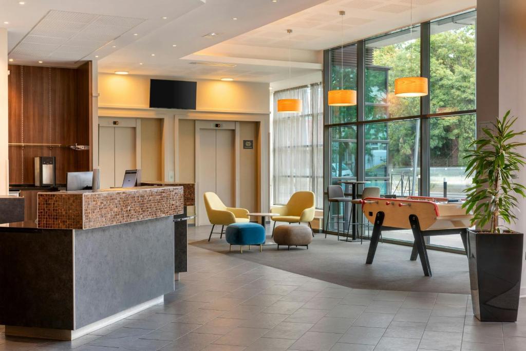 an office lobby with a pool table and chairs at Courtyard by Marriott Paris Saint Denis in Saint-Denis