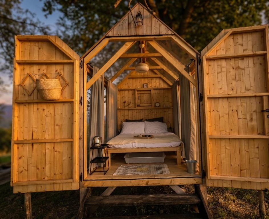a wooden house with a bed in it at Agriturismo Verdesole in Civitella San Paolo