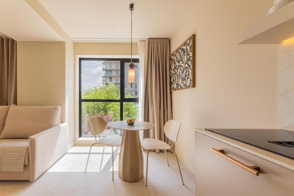 a small kitchen with a table and chairs and a window at A2B Collection Arena in Valencia