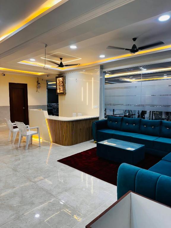 a living room with blue couches and a bar at Vilasa stays and colive in Hyderabad