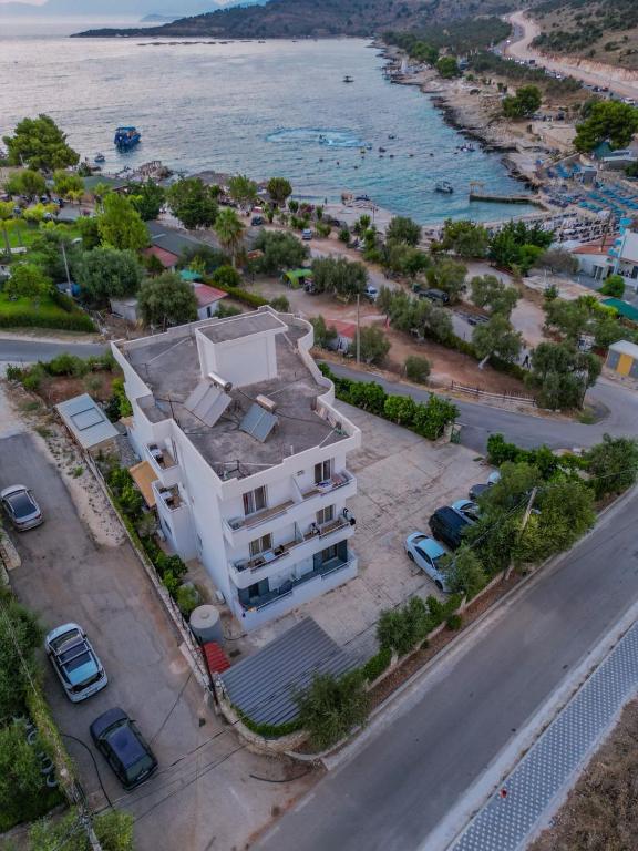 an aerial view of a building next to the ocean at Seli's White Villa in Ksamil