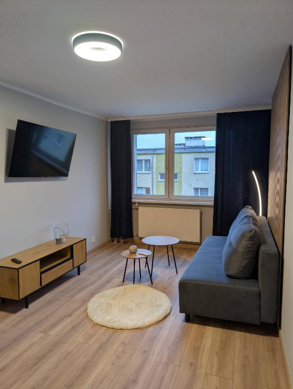 a living room with a couch and a table at Aparto 1 in Złotów
