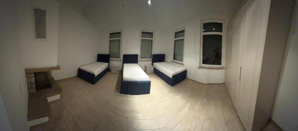 a large room with two beds and windows at Ferienwohnung in Glauchau