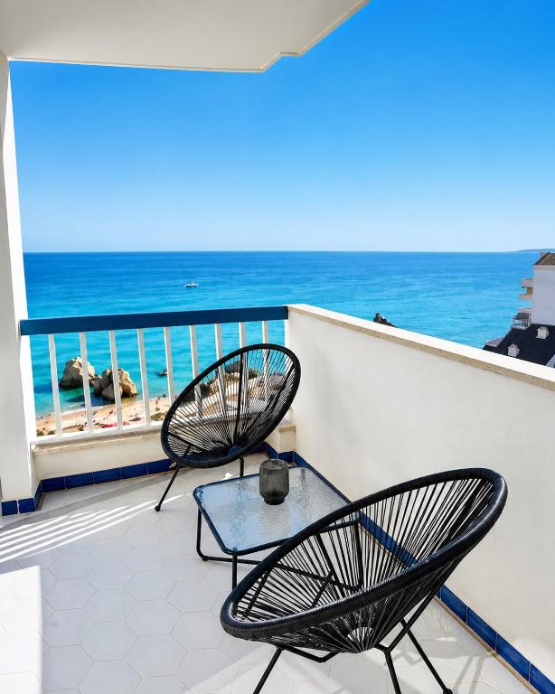 two chairs and a table on a balcony with the ocean at Concorde Luxury Ocean View in Portimão