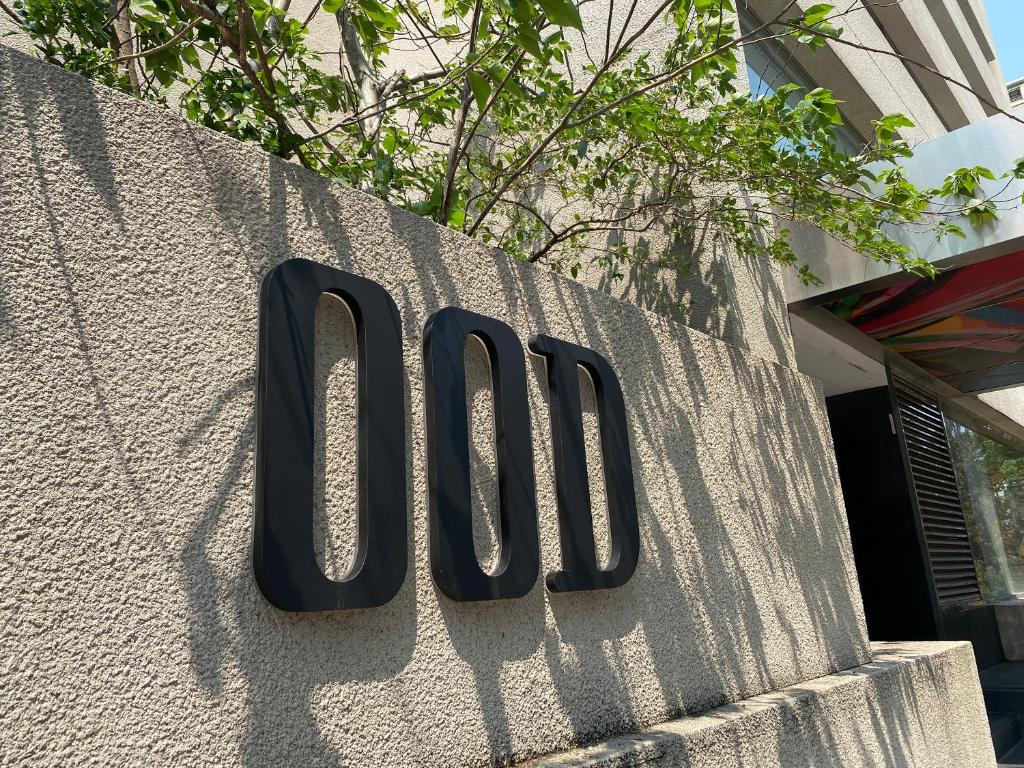 a large black sign on the side of a building at OOD Hotel Taipei DunhuaNorth in Taipei