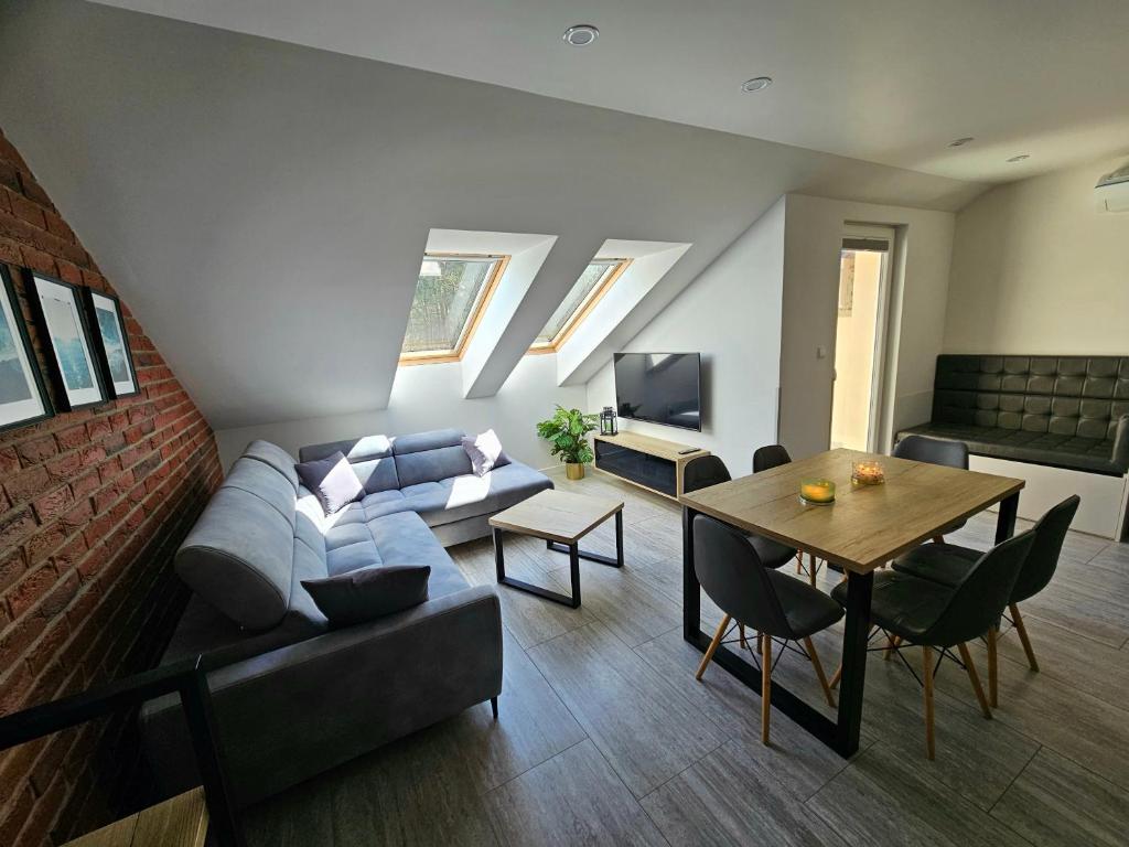 a living room with a couch and a table at Apartamenty Platinum 2 in Łukęcin