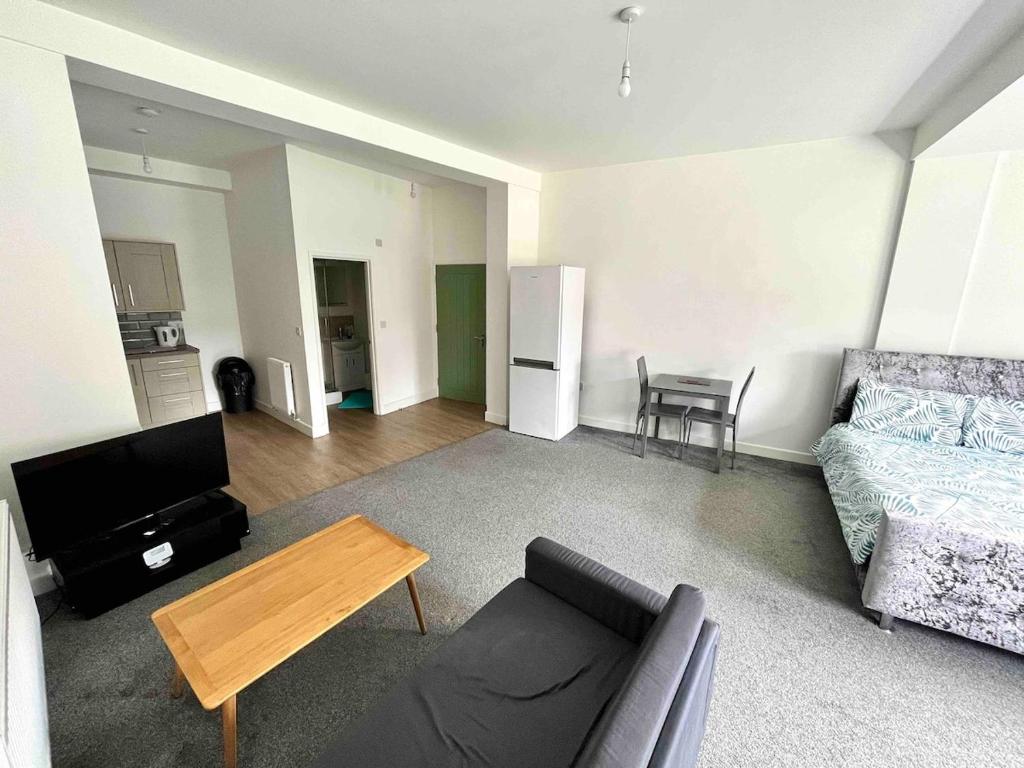 a living room with a couch and a table at The Limes! Flat 3 Private Studio Apartment in Quinton
