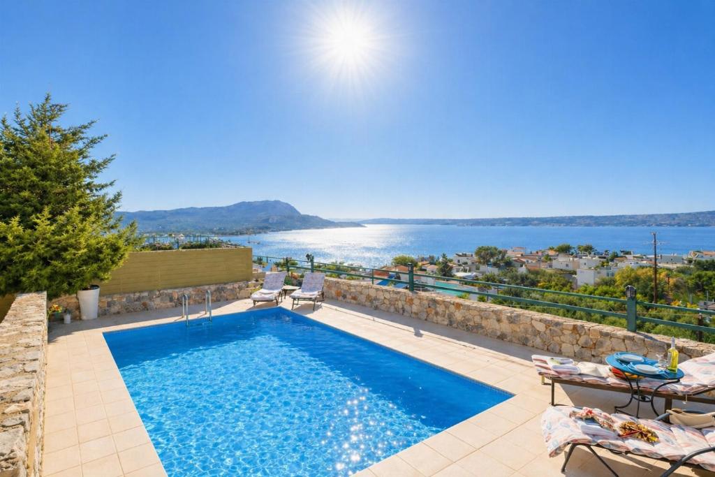 a swimming pool with a view of the water at Ariadne Villa in Plaka