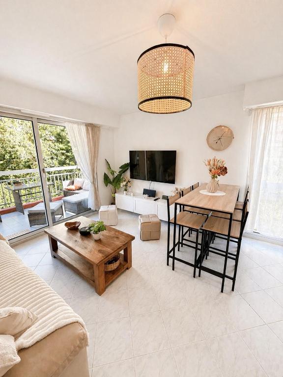 a living room with a table and a couch at Le Saint Michel - MENTON#MONACO - 6 PERSONS - Parking- bord de mer in Menton