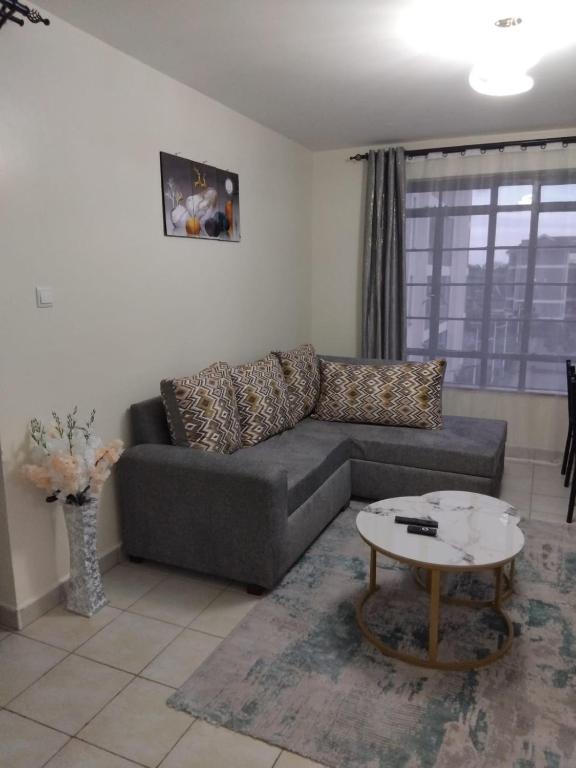 a living room with a couch and a table at Achievers stays in Kitengela 
