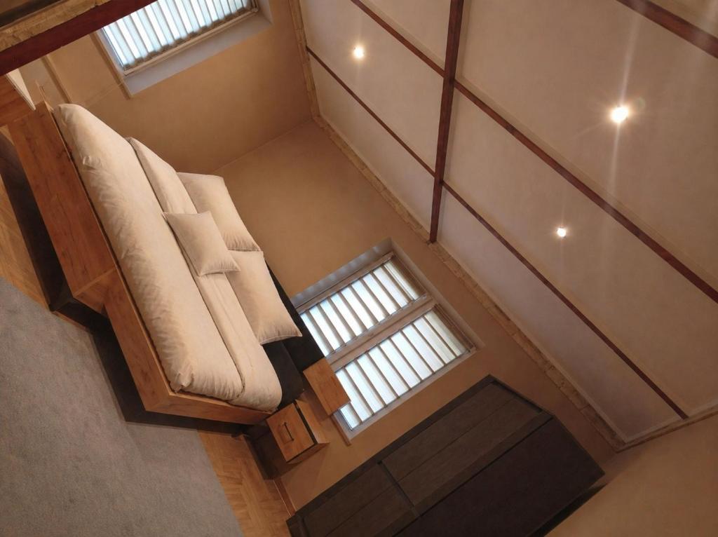 an overhead view of a couch in a room with two windows at Miczurina in Wałbrzych