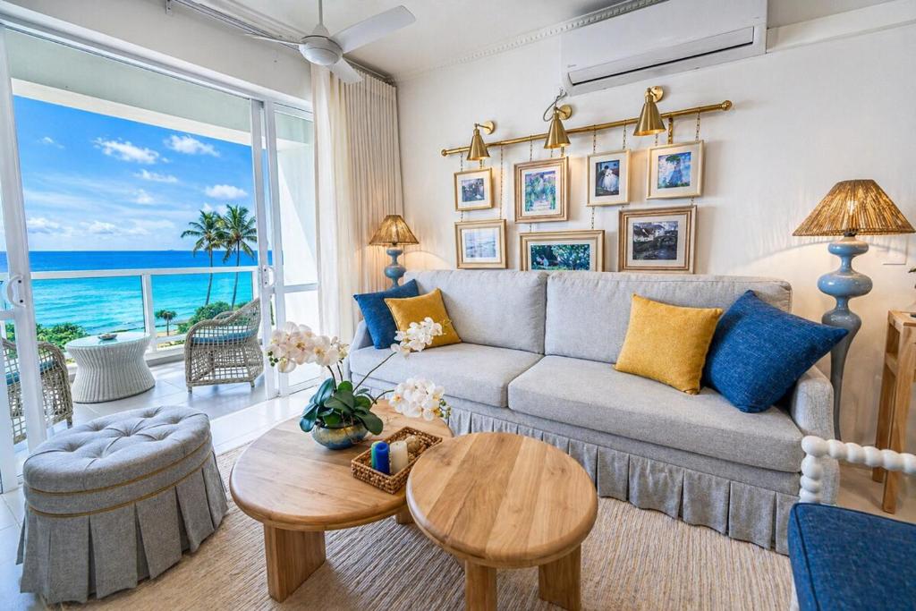 a living room with a couch and a table at Anarma Oceanfront Apartment in Wattala
