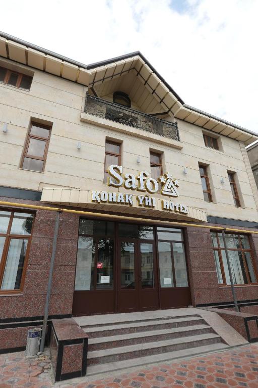 a building with a sign on the front of it at Safo Hotel Turkestan in Türkistan