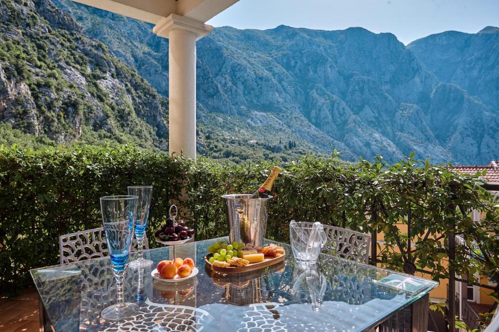 a glass table with a bowl of fruit on it at GREEN HILL 2 Apartmani with POOL in Gornji Orahovac