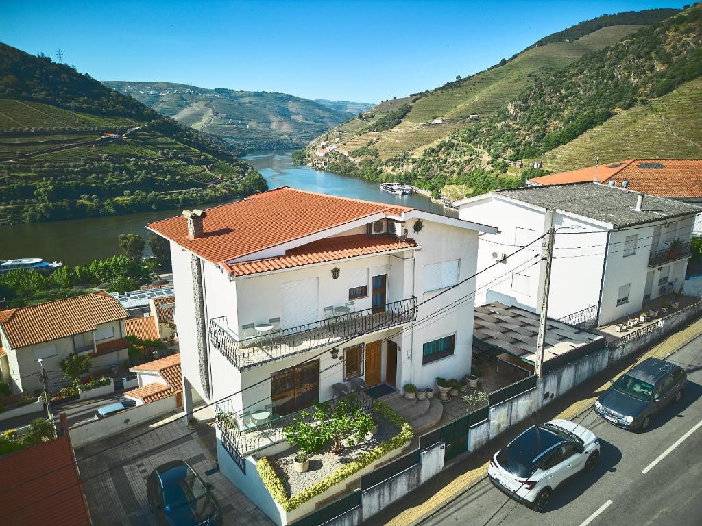 a white house with a view of a river at Douro Panorama Valley in Pinhão