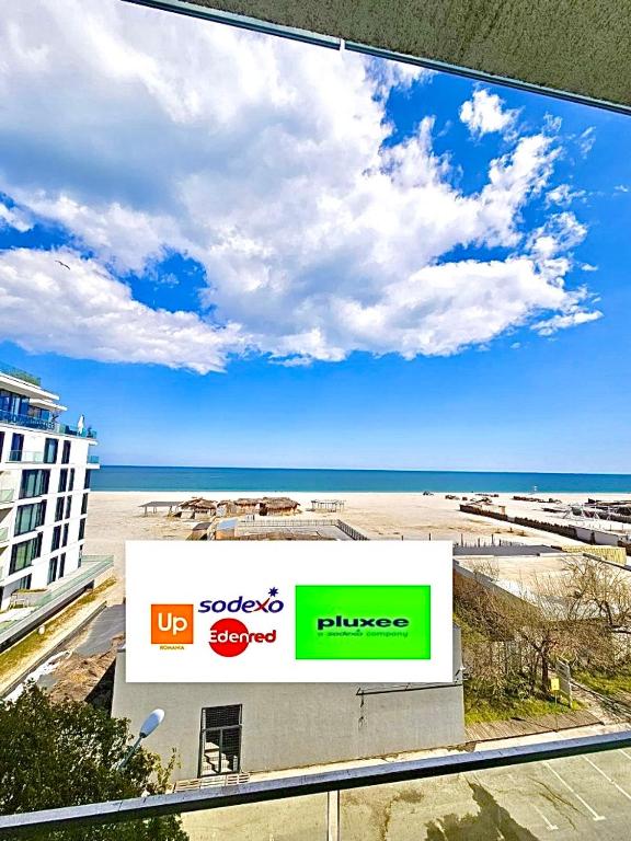 a large tv screen with a view of a beach at Summerland Seaview Premium Apartments in Mamaia
