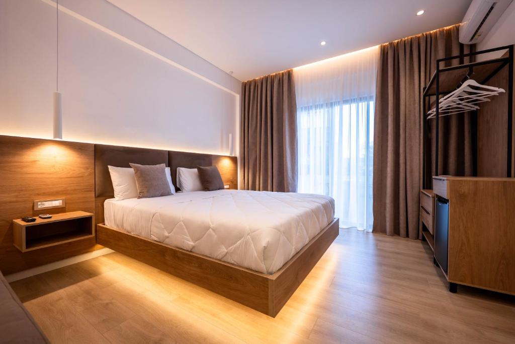 a hotel room with a bed and a television at Villa White in Ksamil