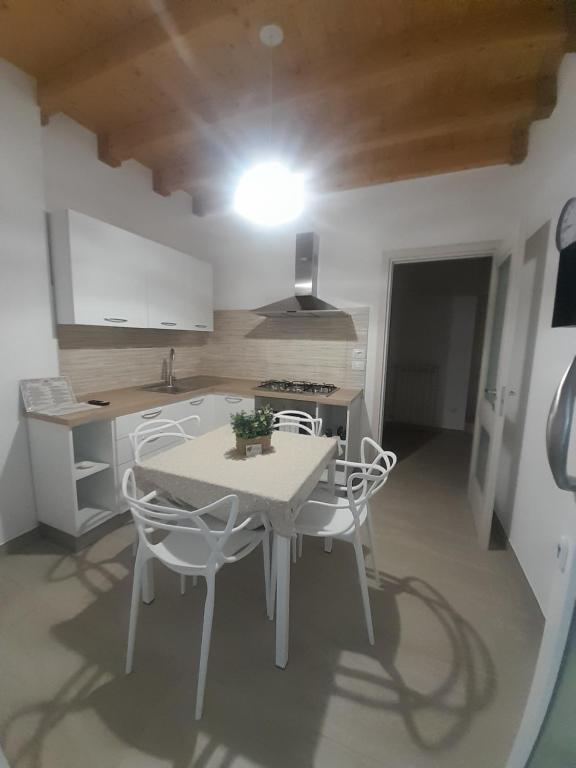 a kitchen with a table and chairs in a room at La Cilinella del Salento in Copertino