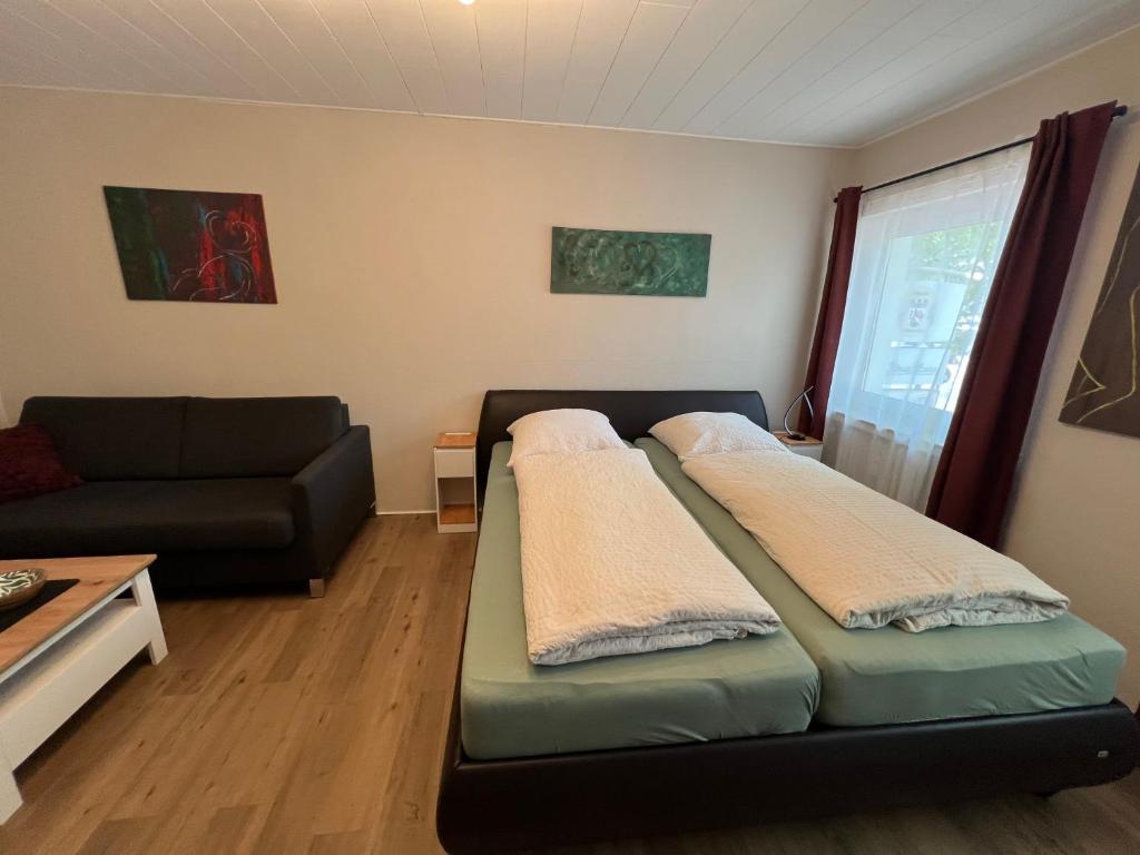 a living room with two beds and a couch at Über dem Dörpken in Wuppertal