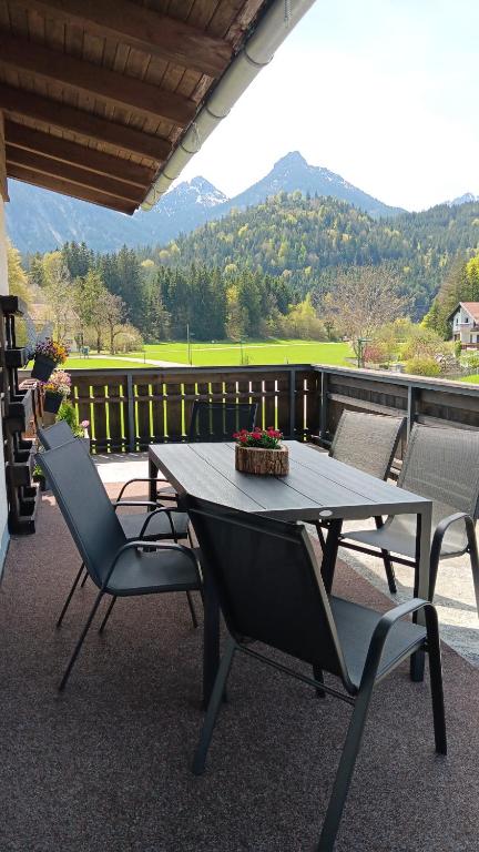 a table and chairs on a balcony with a view at Ferienwohnung Landliebe in Pinswang