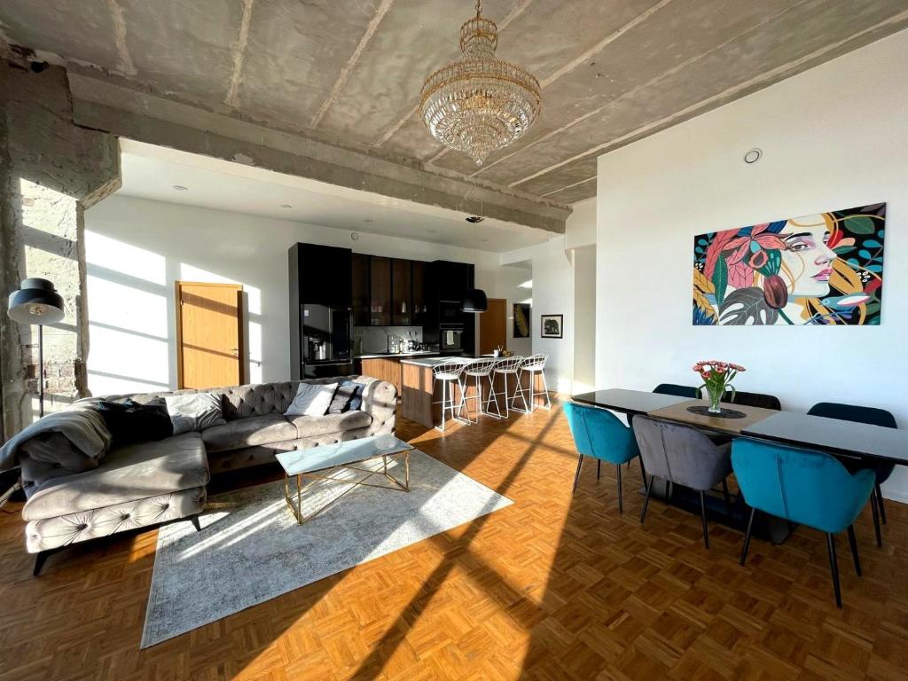 a living room with a couch and a table at Tamula Lake View Apartment in Võru