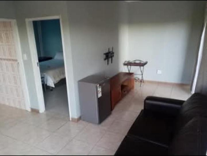 a living room with a couch and a table at The Seige Guesthouse in Pretoria