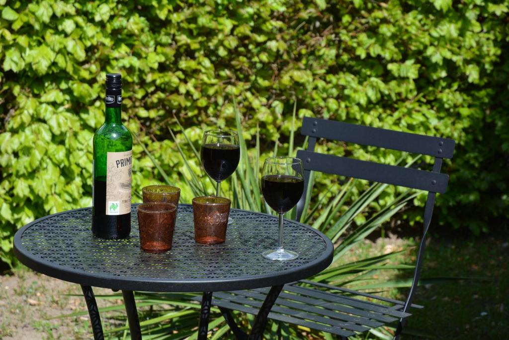 a table with two glasses and a bottle of wine at Ferienhaus Abendrot in Basedow