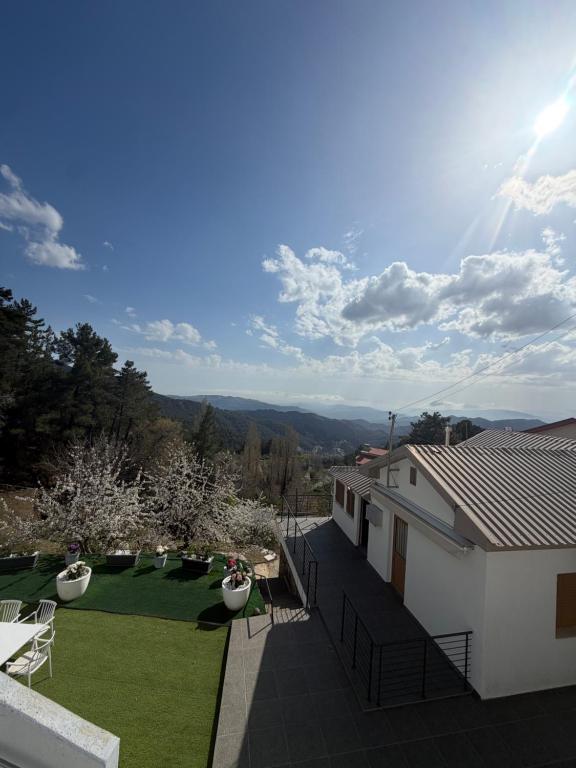 a house with a view of a yard at Petrovounos Villa in Prodromos