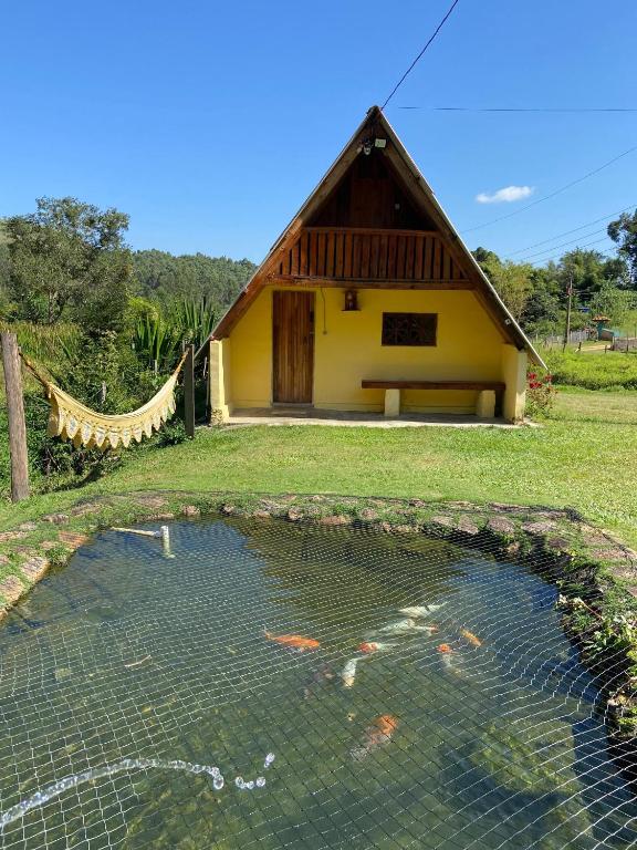 a koi pond in front of a house at Abrigo Pedrão in Pedralva