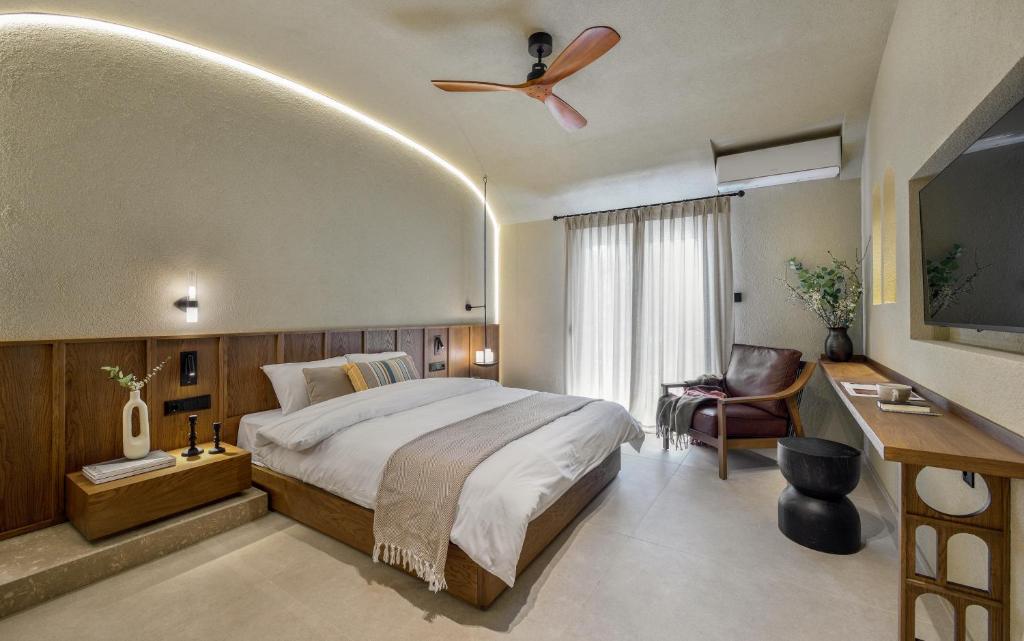 a bedroom with a bed and a ceiling fan at DOMUS GEORGiO in Litochoro