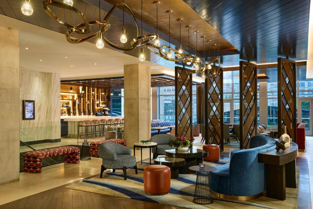 a lobby of a hotel with chairs and tables at Renaissance New York Midtown Hotel in New York