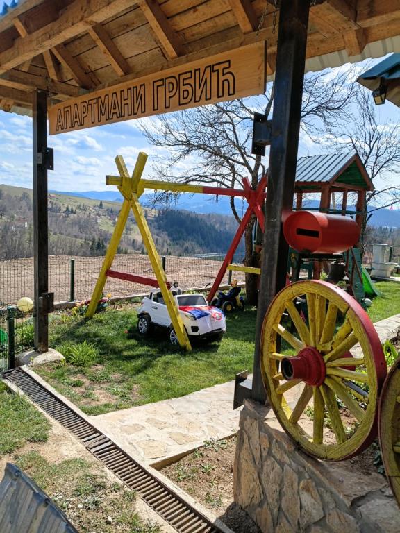 a sign with aokedoked wheel next to a playground at Vila Prevoja in Nova Varoš