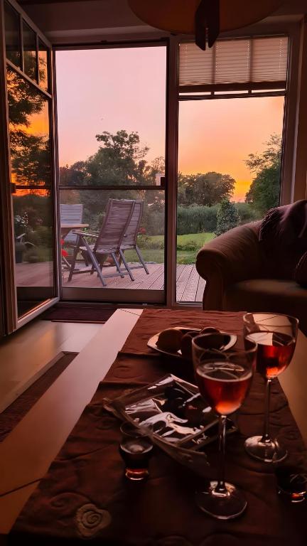 a table with two glasses of wine on top of it at Ferienhaus mit Naturblick in Putbus