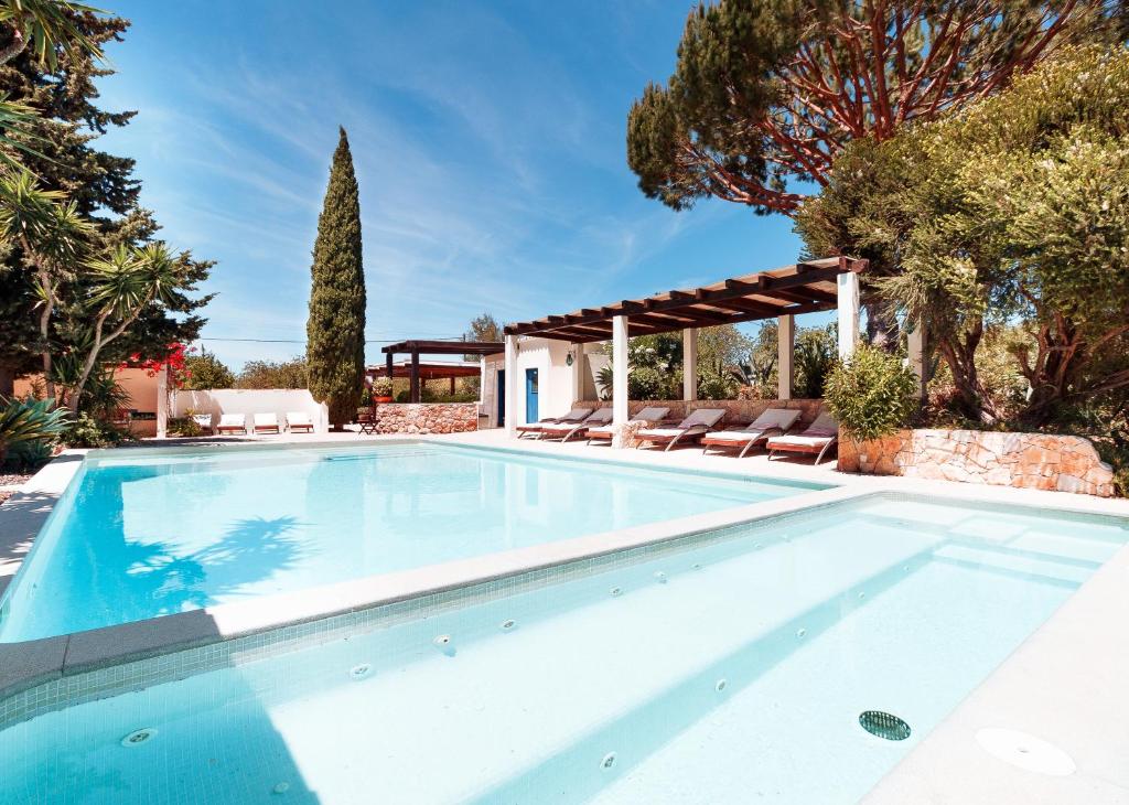 a swimming pool in a villa with trees at Casa Porta Azul in Boliqueime