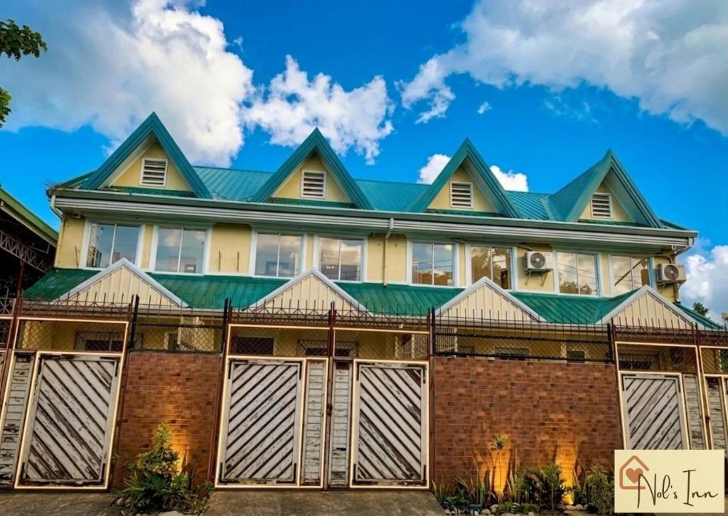 a large house with a green roof at Nol's Inn in Iloilo City